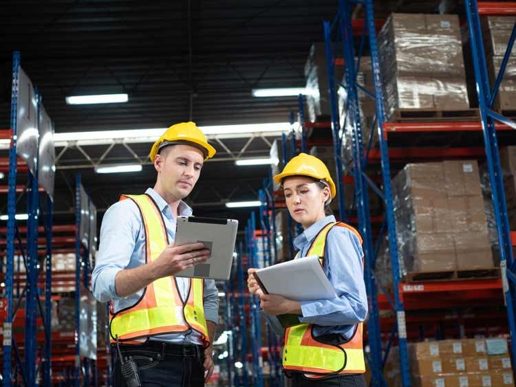 Warehouse workers using supplier management software